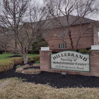 Entrance sign for Hillebrand Rehabilitation and Nursing Center, showcasing the landscaped area.