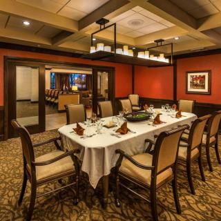 A beautifully set dining table in an elegant restaurant setting.
