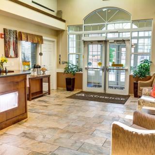 A welcoming hotel lobby with a reception desk and comfortable seating.