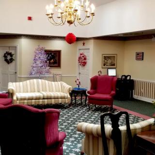 A warmly decorated living room with elegant furniture and festive holiday decorations.
