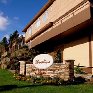 The elegant exterior of the building, featuring a welcoming sign and well-maintained landscaping.