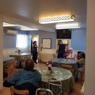 A cozy dining area with people seated at tables.