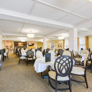 An elegant dining room with neatly arranged tables and chairs, ready for guests.
