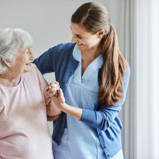 A nurse assists an elderly woman, showcasing compassion and care.
