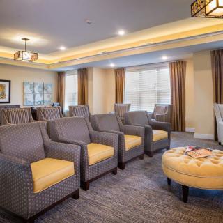 A cozy living room with arranged seating and warm lighting.