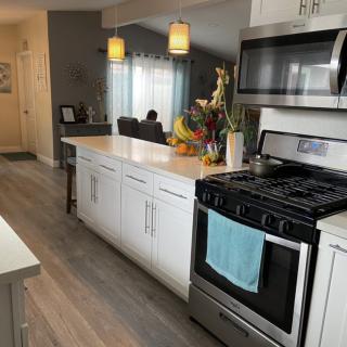 A modern kitchen interior with stainless steel appliances and white cabinetry.