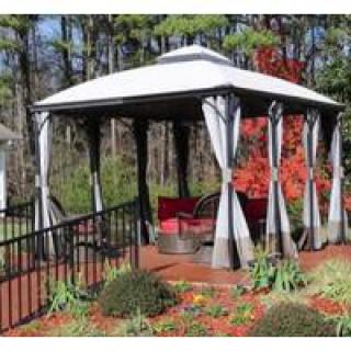 A charming gazebo set in a garden with autumn foliage and outdoor furniture.