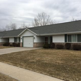 A suburban residential house with a garage and driveway.