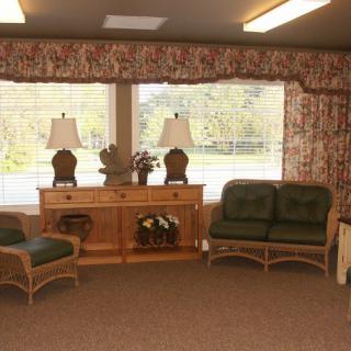 A cozy waiting room with comfortable seating and large windows.