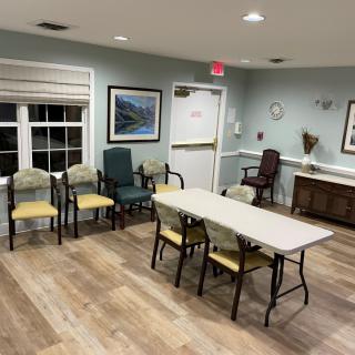 A small waiting or meeting area with chairs and a table.