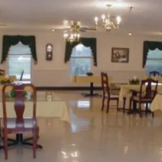 An elegantly arranged dining room with tables, chairs, and chandeliers.