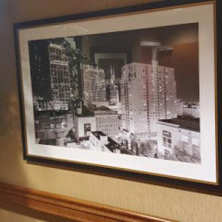 A striking black and white photograph showcasing a city skyline, elegantly framed and displayed on a wall.