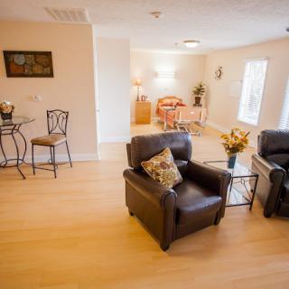 A cozy living room with leather armchairs and a warm ambiance.