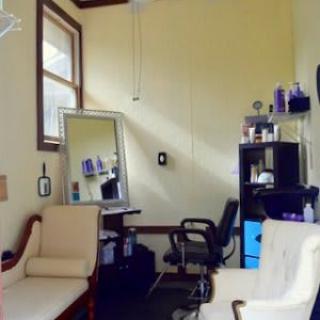 A well-organized salon room with chairs and beauty products.