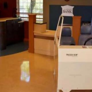 A waiting area in a clinic with chairs and a reception desk.