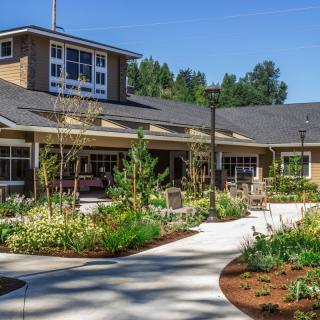 A landscaped garden pathway leading to a residential building.