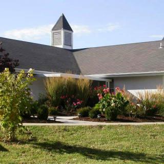 A church building surrounded by a landscaped garden.