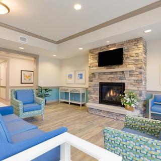 A modern living room with a cozy fireplace and comfortable seating.