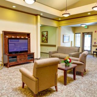 A cozy living room with comfortable seating and a large television.