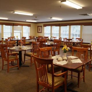 An indoor dining area with neatly arranged tables and chairs, featuring a cozy atmosphere.
