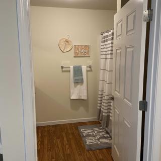 A neatly arranged bathroom with towels and a shower curtain.