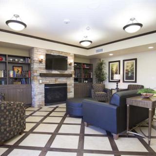 A modern living room with a fireplace, television, and comfortable seating area.