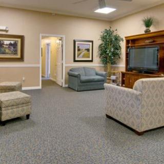 A cozy living room with sofas, a TV, and decorative elements.