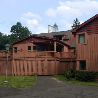 A charming wooden building surrounded by greenery.