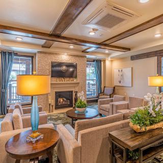 A cozy and modern living room featuring a fireplace, stylish furniture, and elegant lighting.