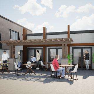 A modern outdoor patio with a pergola, featuring people sitting and socializing at tables.