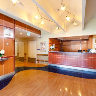 A modern reception area with wood paneling and contemporary lighting fixtures.
