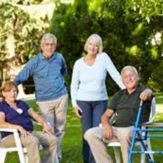 A group of seniors enjoying a relaxing day outdoors in a garden setting.