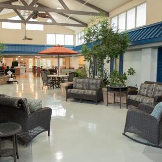 A spacious lobby area with comfortable seating and indoor plants.
