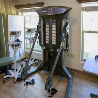 A cable machine in a fitness room for strength training exercises.