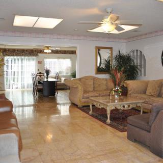 Spacious living room with comfortable seating and adjacent dining area.