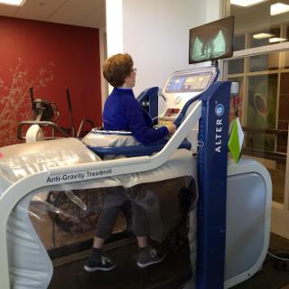 A person using a specialized exercise machine designed for rehabilitation.