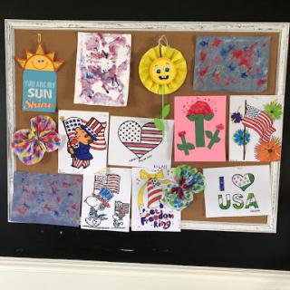 A vibrant bulletin board showcasing various children's art projects with patriotic themes.