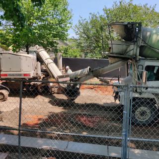 A concrete mixer and equipment working at a construction site.