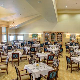 An elegant dining room with neatly arranged tables and chairs.