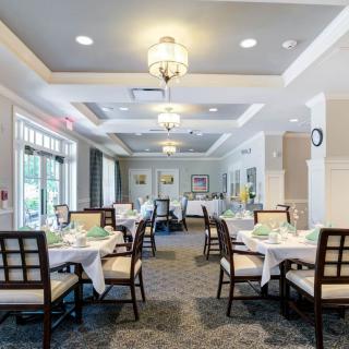 An elegant dining room with neatly set tables and stylish lighting.