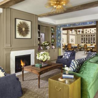 A stylish and cozy living room with a modern design, featuring a fireplace and elegant decor.
