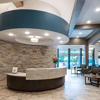 A modern lobby with a sleek reception desk and comfortable seating.