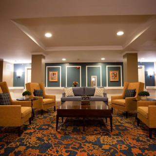 A cozy lobby area with comfortable seating and elegant lighting.