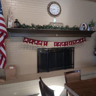 A cozy living room setting with festive Christmas decorations adorning the fireplace mantel.