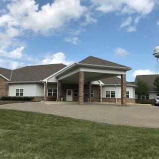 A modern healthcare facility with a welcoming entrance under a bright sky.