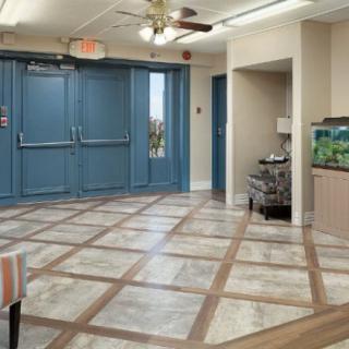 A spacious hallway with blue double doors and a fish tank.