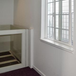An interior space with an elevator and a window.