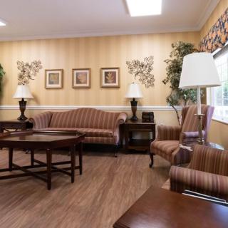 A cozy living room with classic furniture and warm lighting.