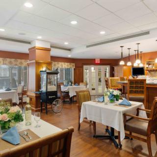 A cozy and elegantly decorated restaurant dining area with neatly arranged tables and chairs.