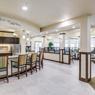 A modern dining area with bar seating and elegant lighting.